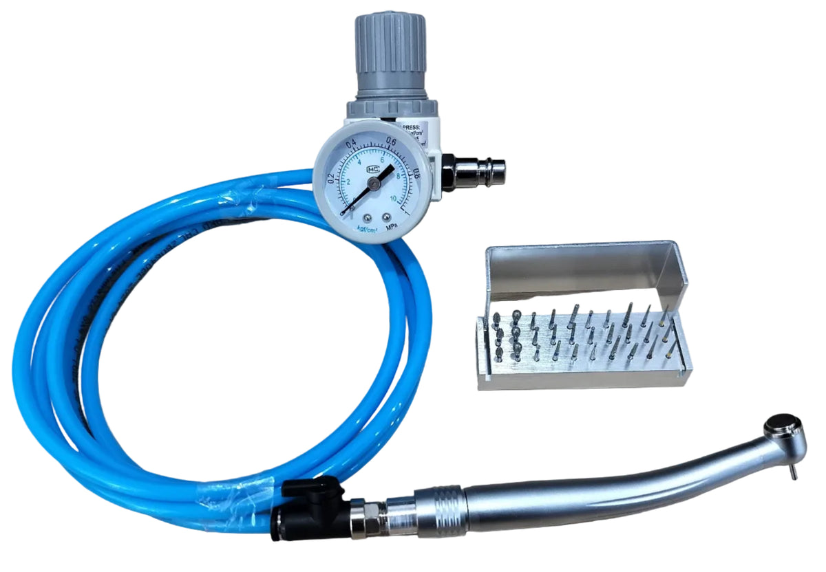 A dental handpiece with a coiled blue air hose, a silver and gray regulator, a small metal accessory tray, and a curved metal handpiece tip, arranged on a light wood surface.