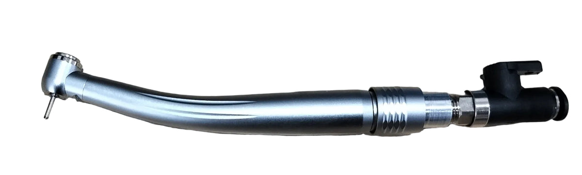 A curved metallic dental handpiece with a black connector cap, placed on a light wood-grained tabletop.